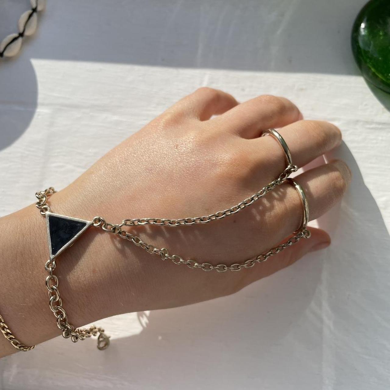 Urban Outfitters hand ring chain gold with black... Depop
