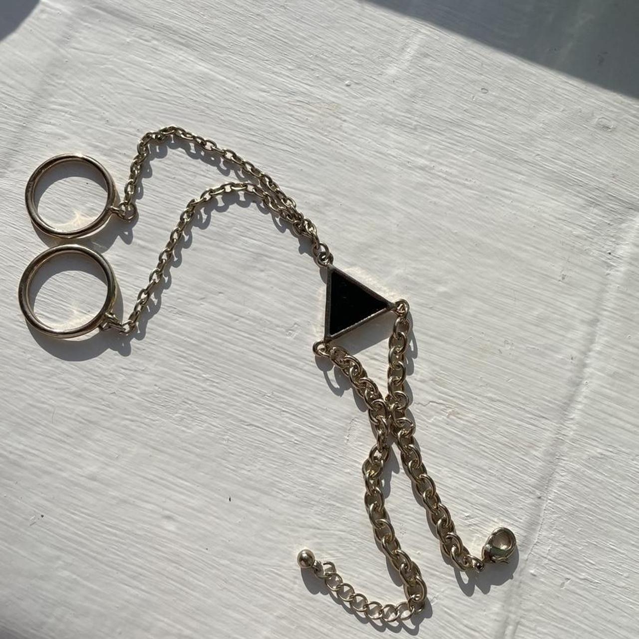 Urban Outfitters hand ring chain gold with black... Depop