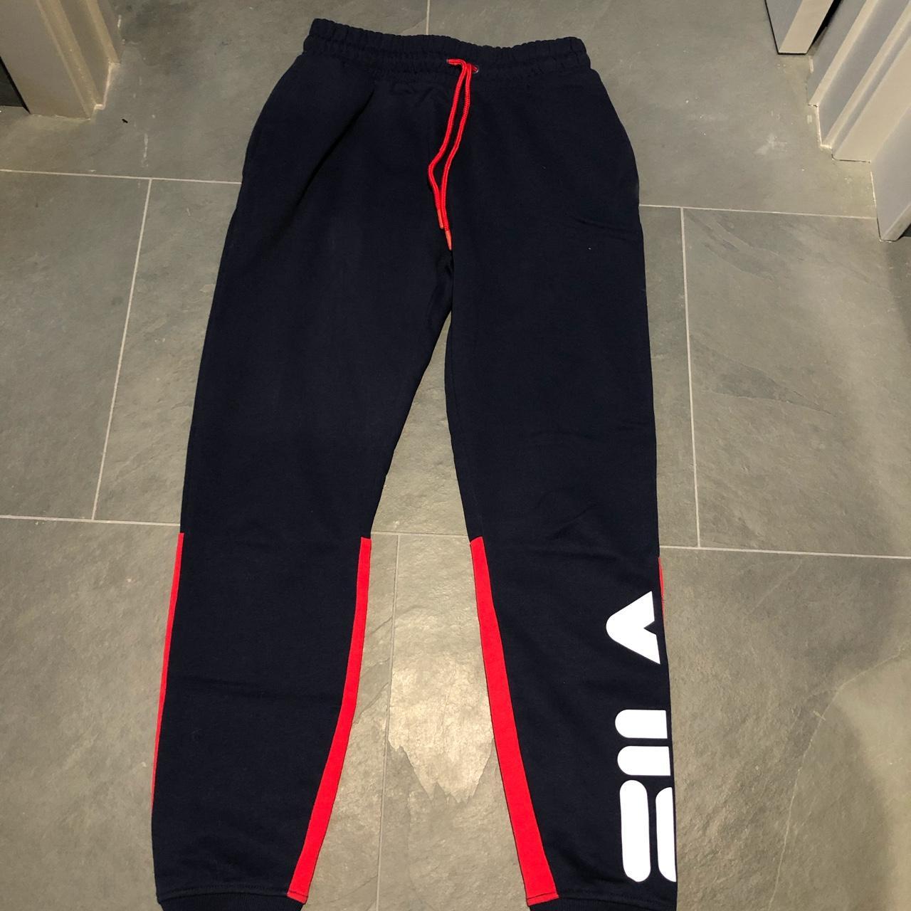 Navy and red FILA tracksuit bottoms Condition -... - Depop