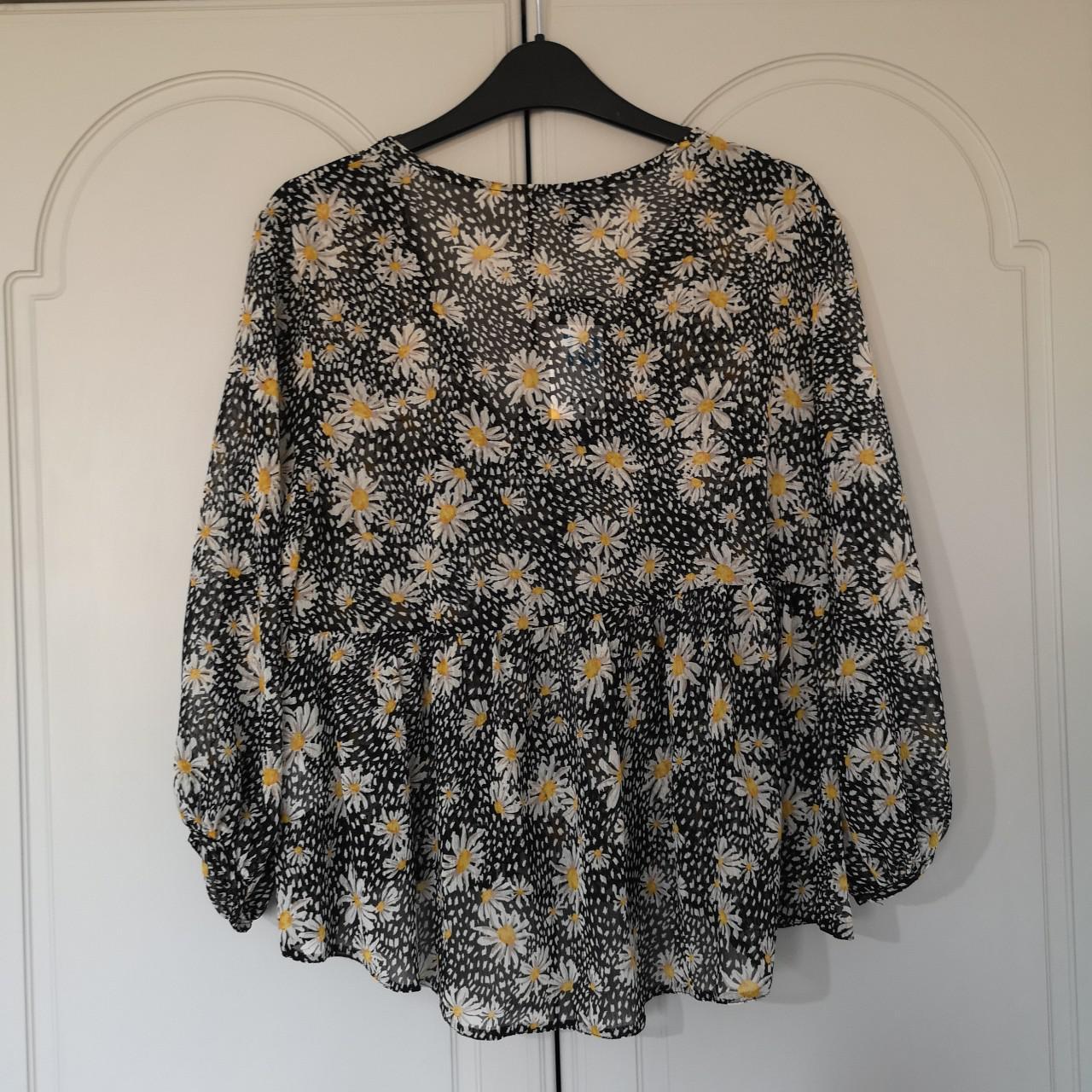 Primark black blouse with daisy print. Dipped hem at... - Depop