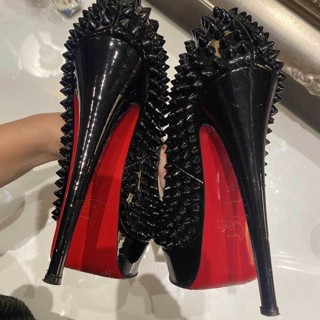 black spike shoes with red bottoms