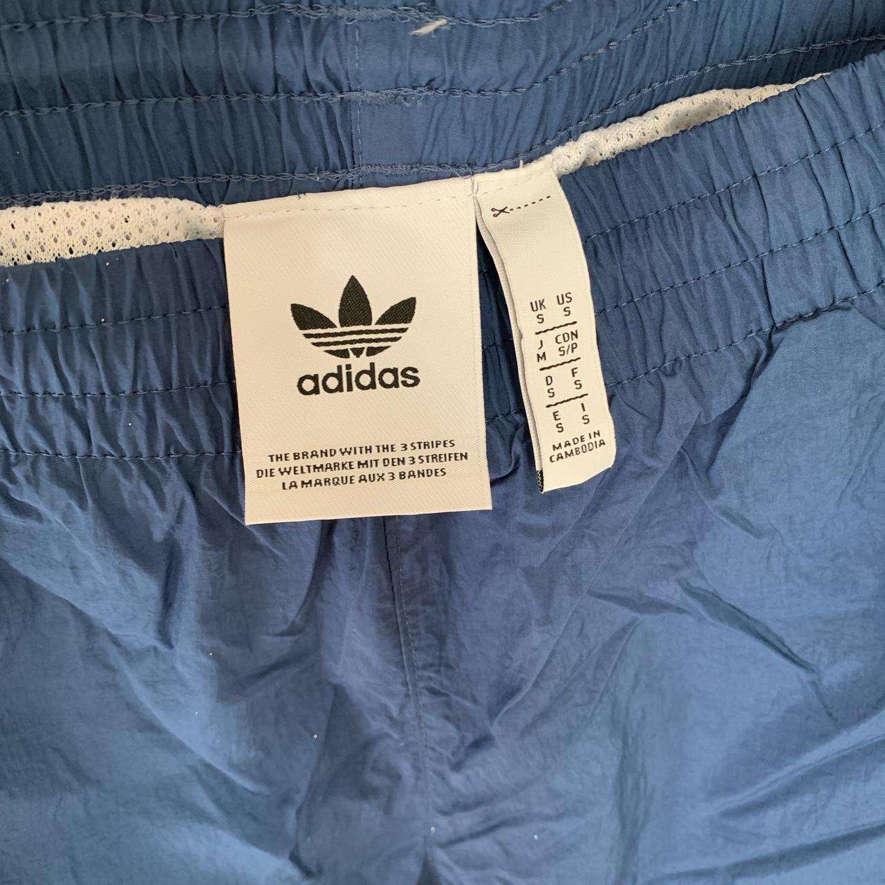 Blue adidas windbreaker track pants/jogger size... Depop