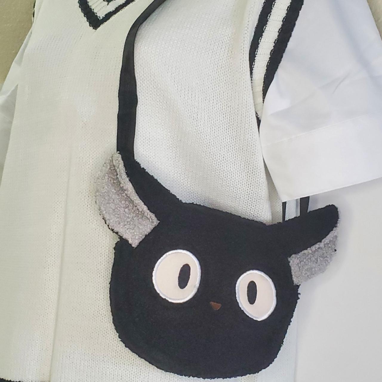 A cute black cat bag that can hold small items,... Depop