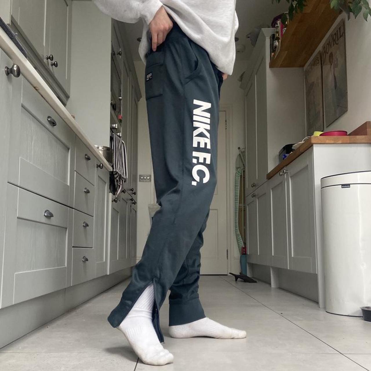 Grey Nike Joggers with adjustable drawstring waist... Depop