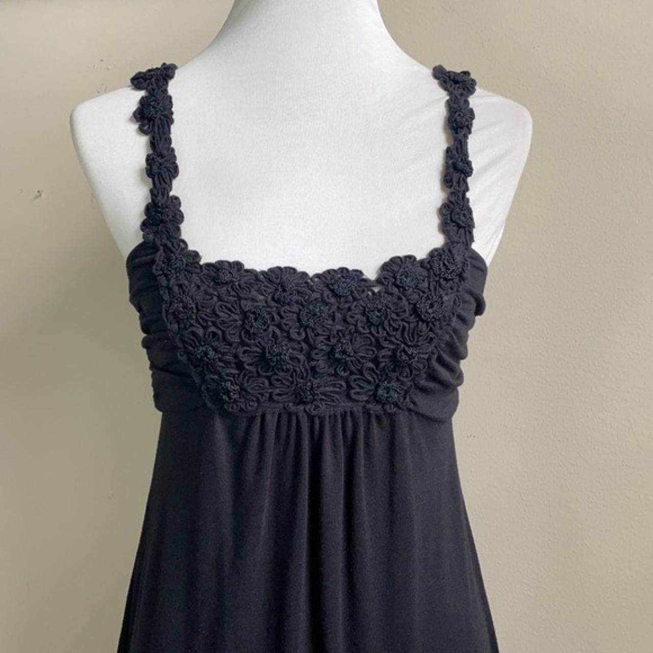 Black babydoll dress with floral designs on the... Depop