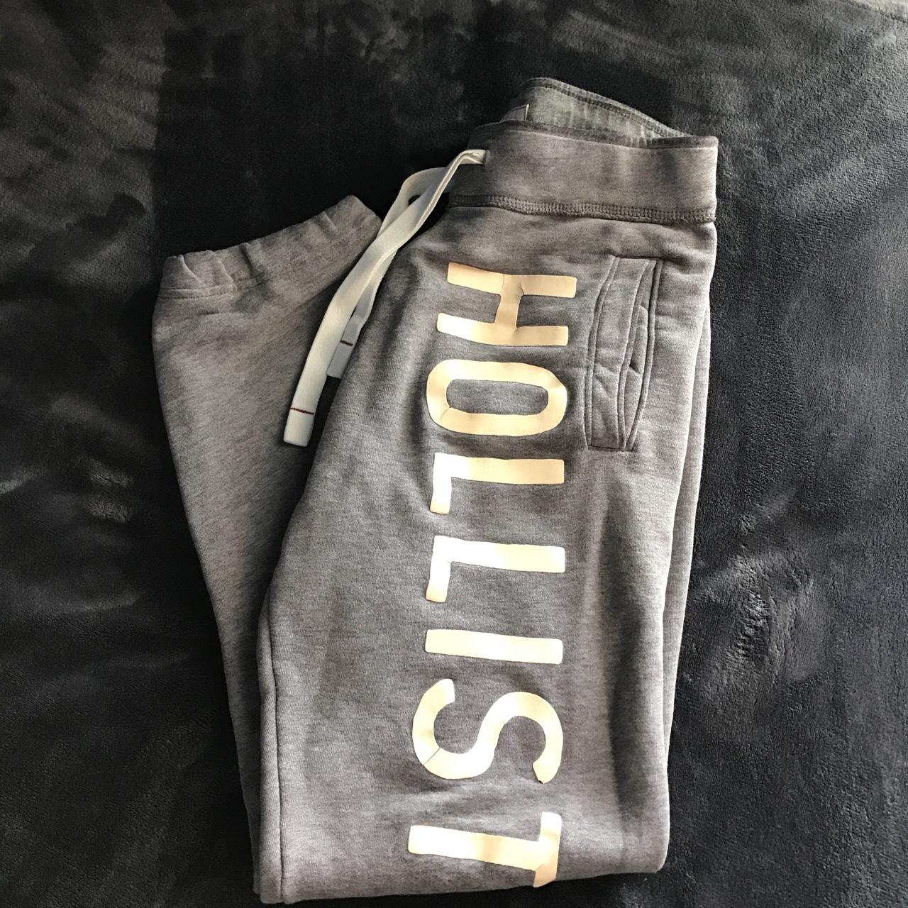 A pair of grey hollister sweatpants in a men's size - Depop