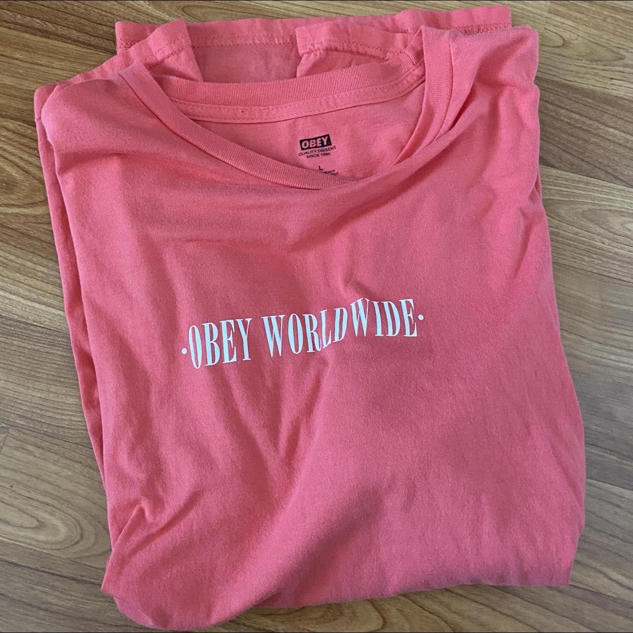 Salmon pink OBEY WORLDWIDE logo white text short... - Depop