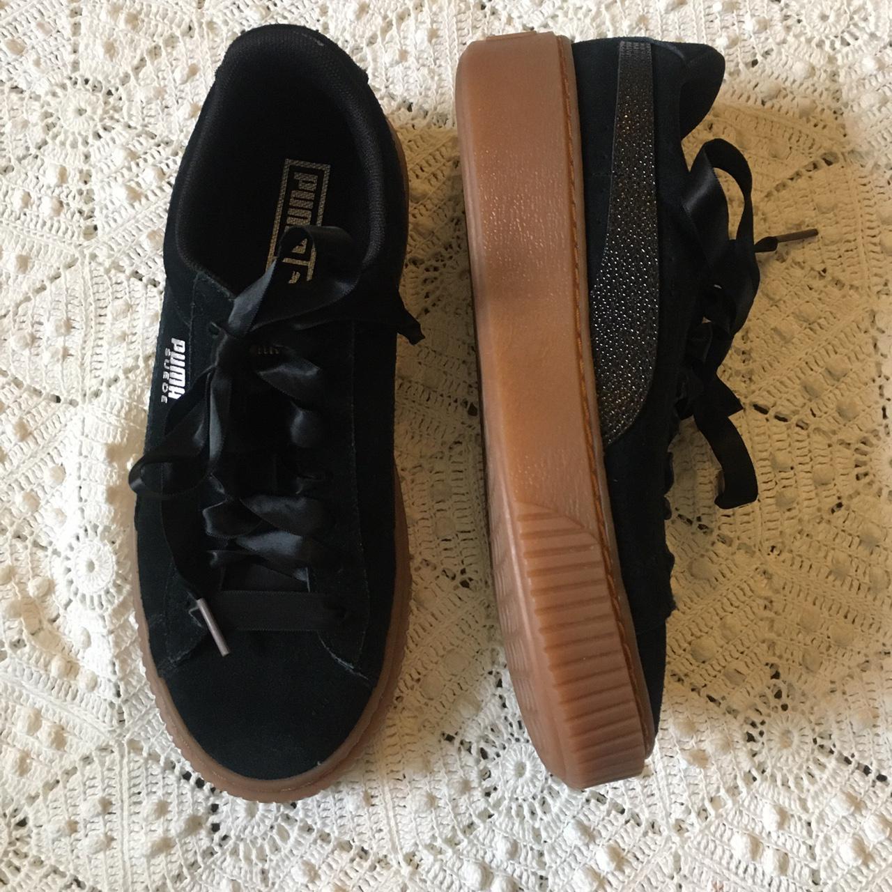 Black suede Pumas with brown platform gum sole and