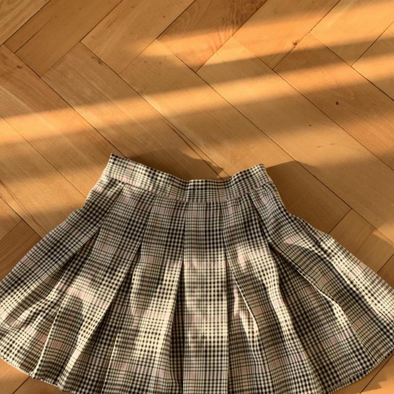 a plaid pink black and beige skirt (it’s quite short) - Depop