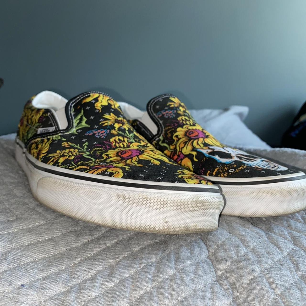 Black and yellow shop slip on vans