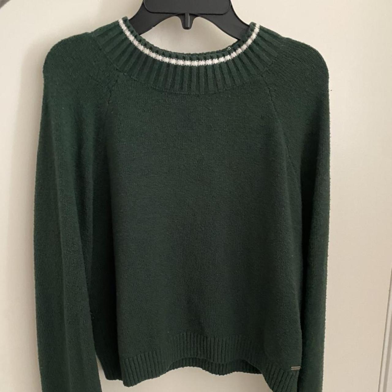 This green sweater with white stripes along the... - Depop