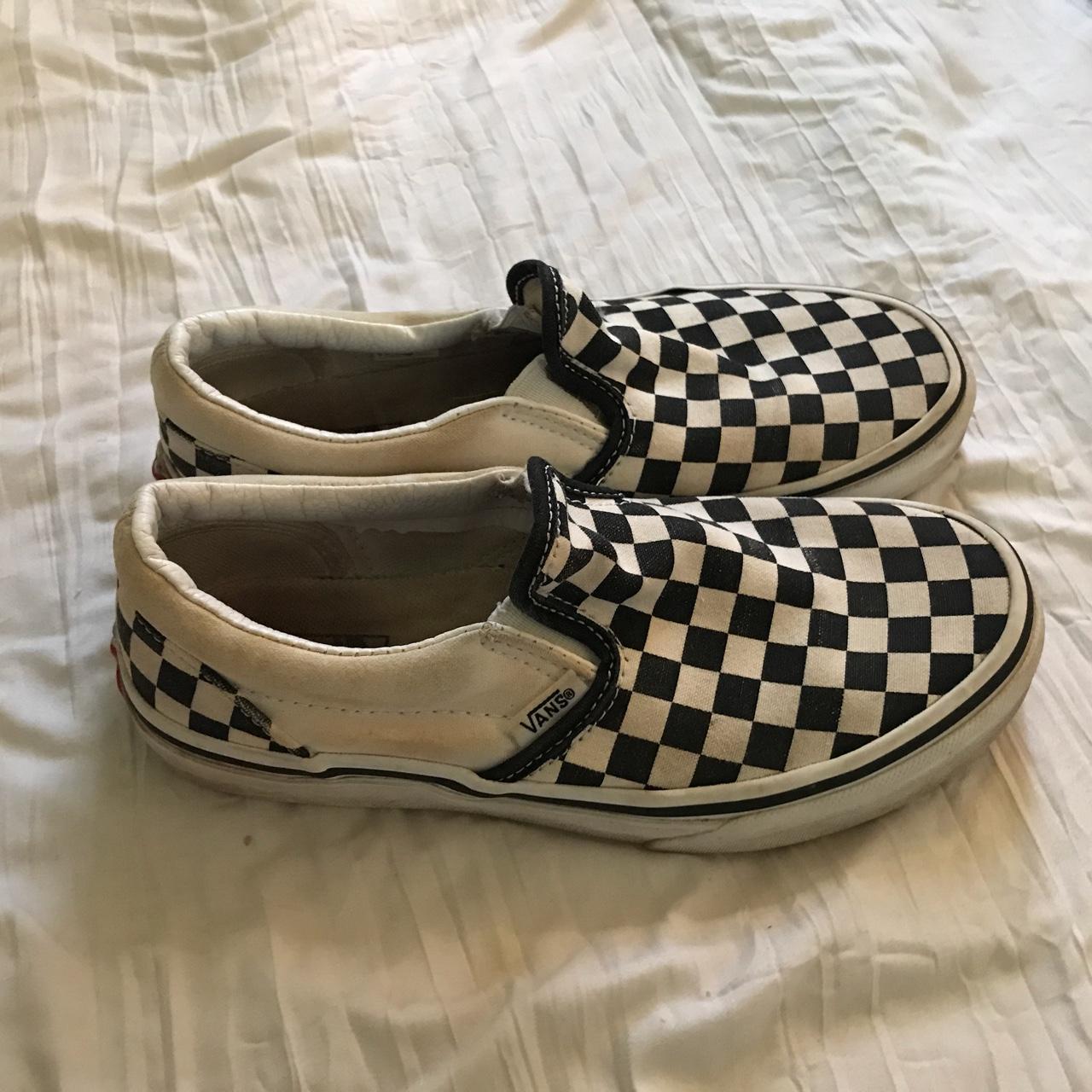 These are white and black checkered vans slip ons... - Depop