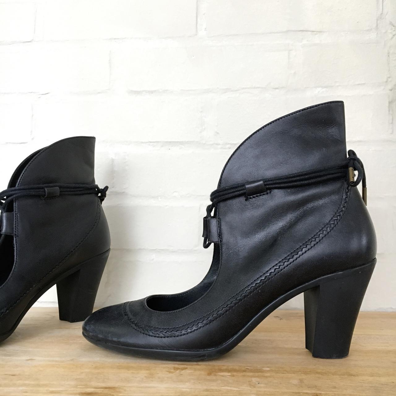 Black leather heeled booties made by Camper, with a... - Depop