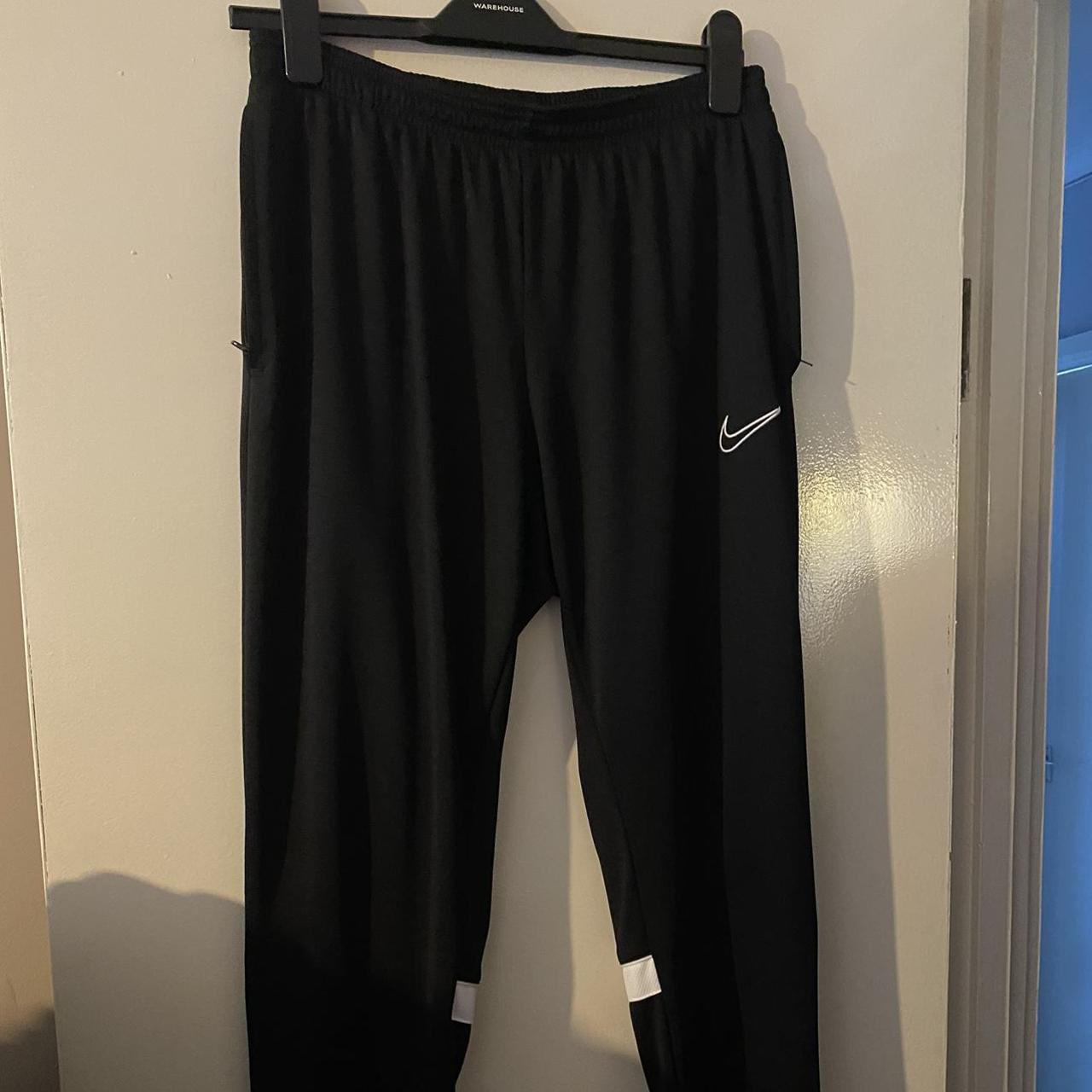 black with white stripes on the back nike tracksuit... Depop