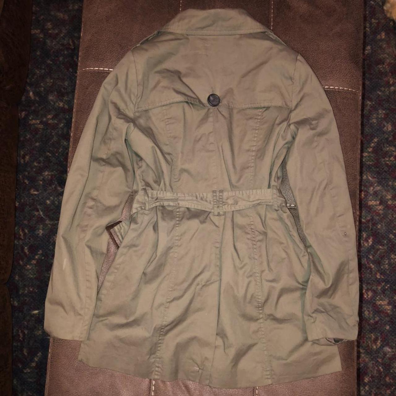 Army green colored double breasted trenchcoat with a... - Depop