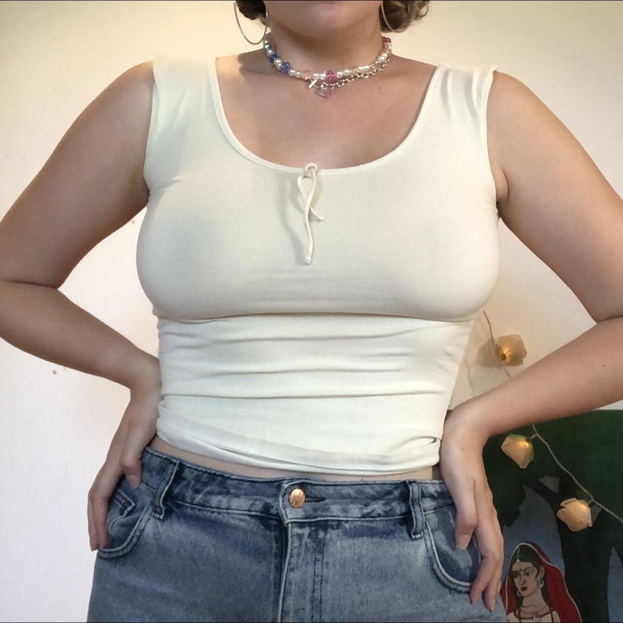 Pale yellow vest top. Very flattering and form... - Depop