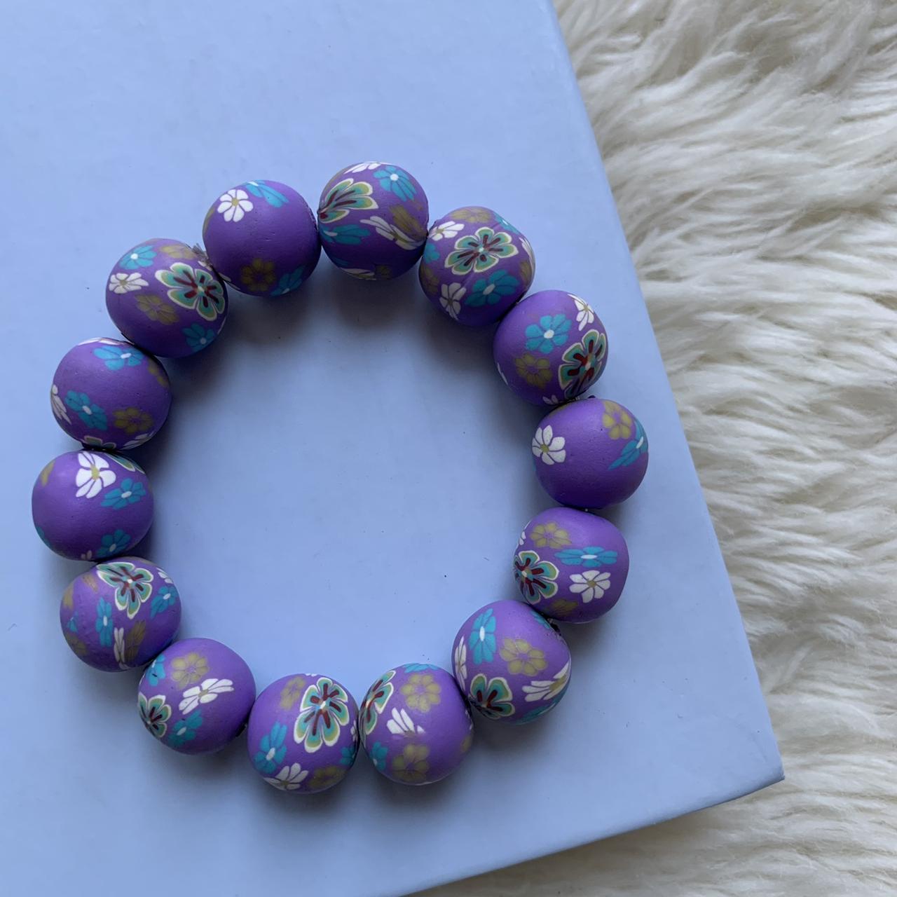 clay beads bracelets. one is purple with a flower - Depop