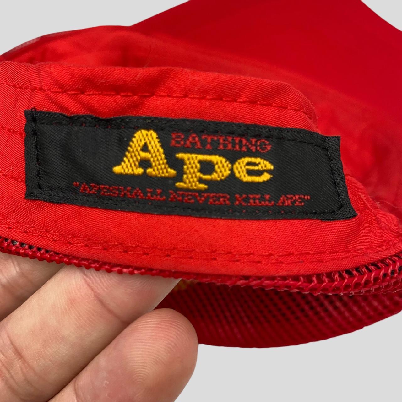 bape kaws trucker hat