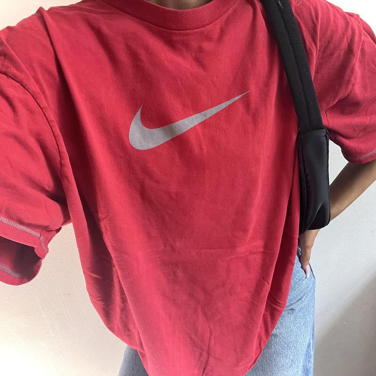 red nike shirt with black swoosh