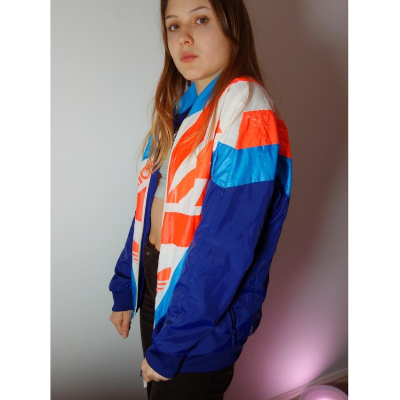 Funky bright coloured Adidas shell jacket. Model is