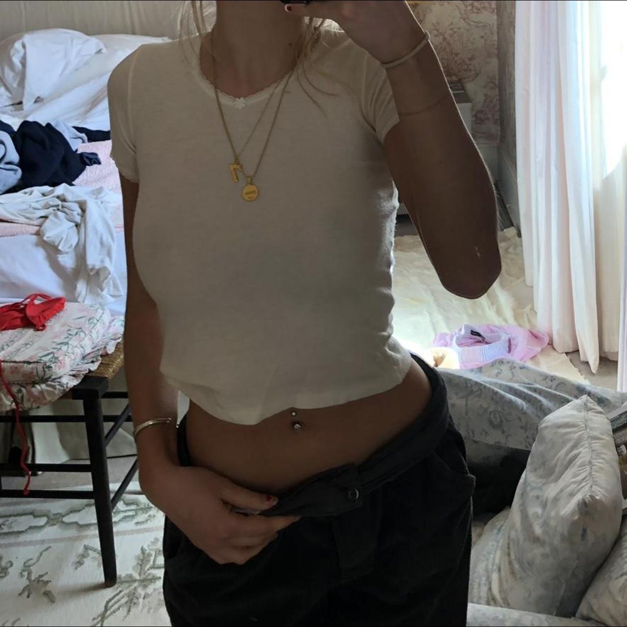 Really cute white baby tee with little flower on v... - Depop