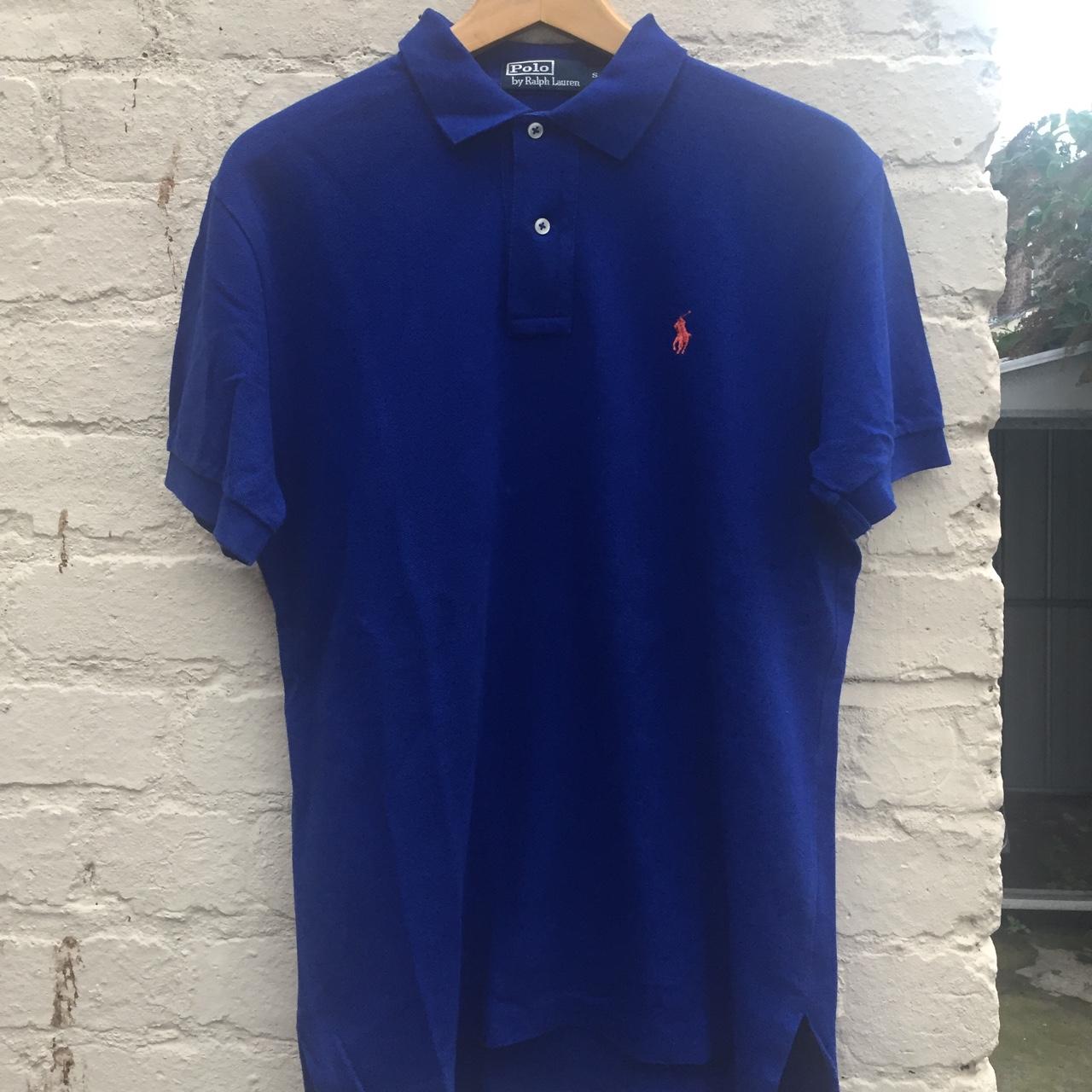 blue polo shirt with orange horse