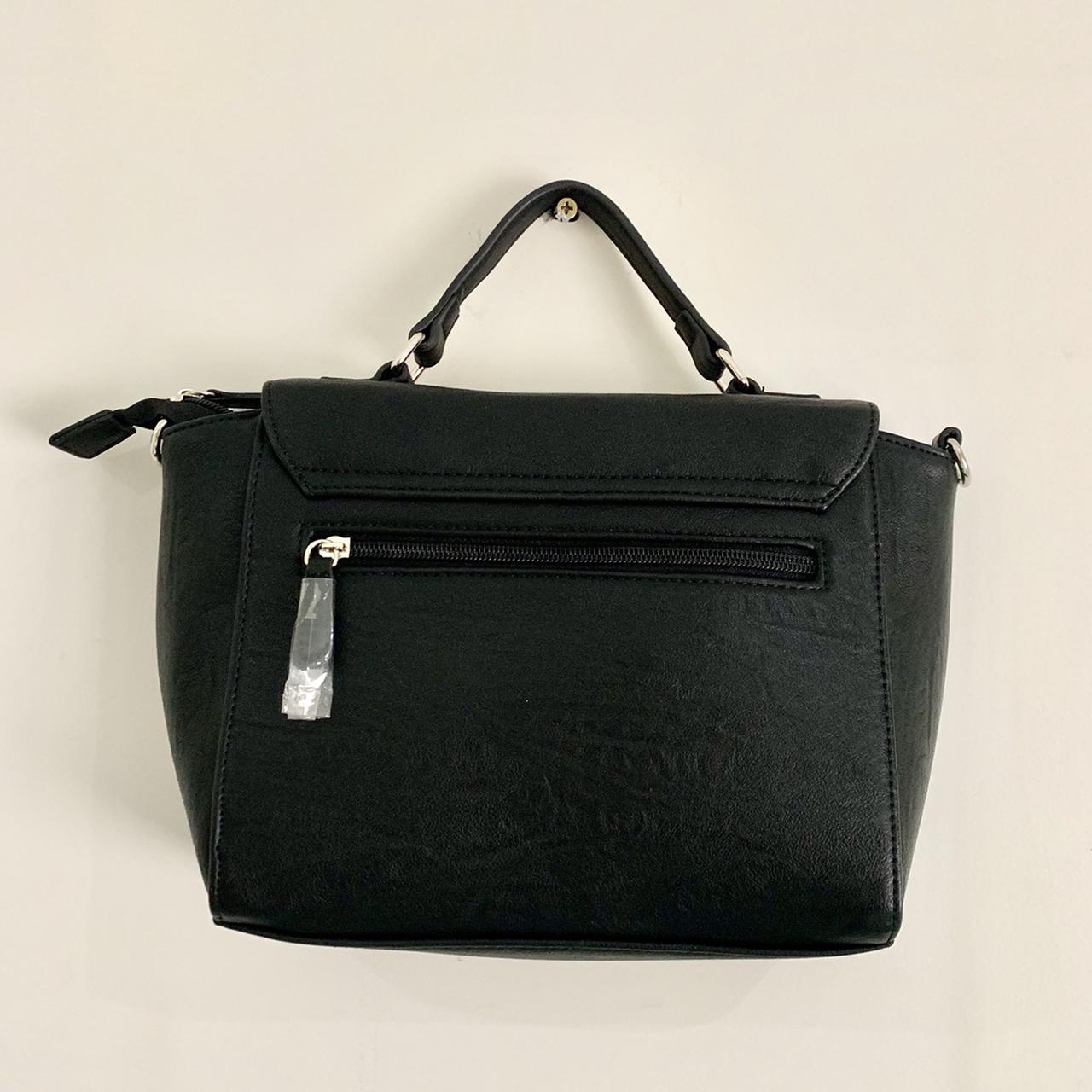 A black medium sized handbag with a pop of... Depop