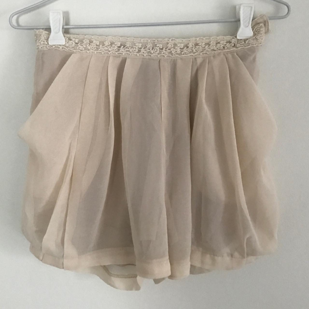 Cream chiffon high waisted shorts with lace detailing. - Depop