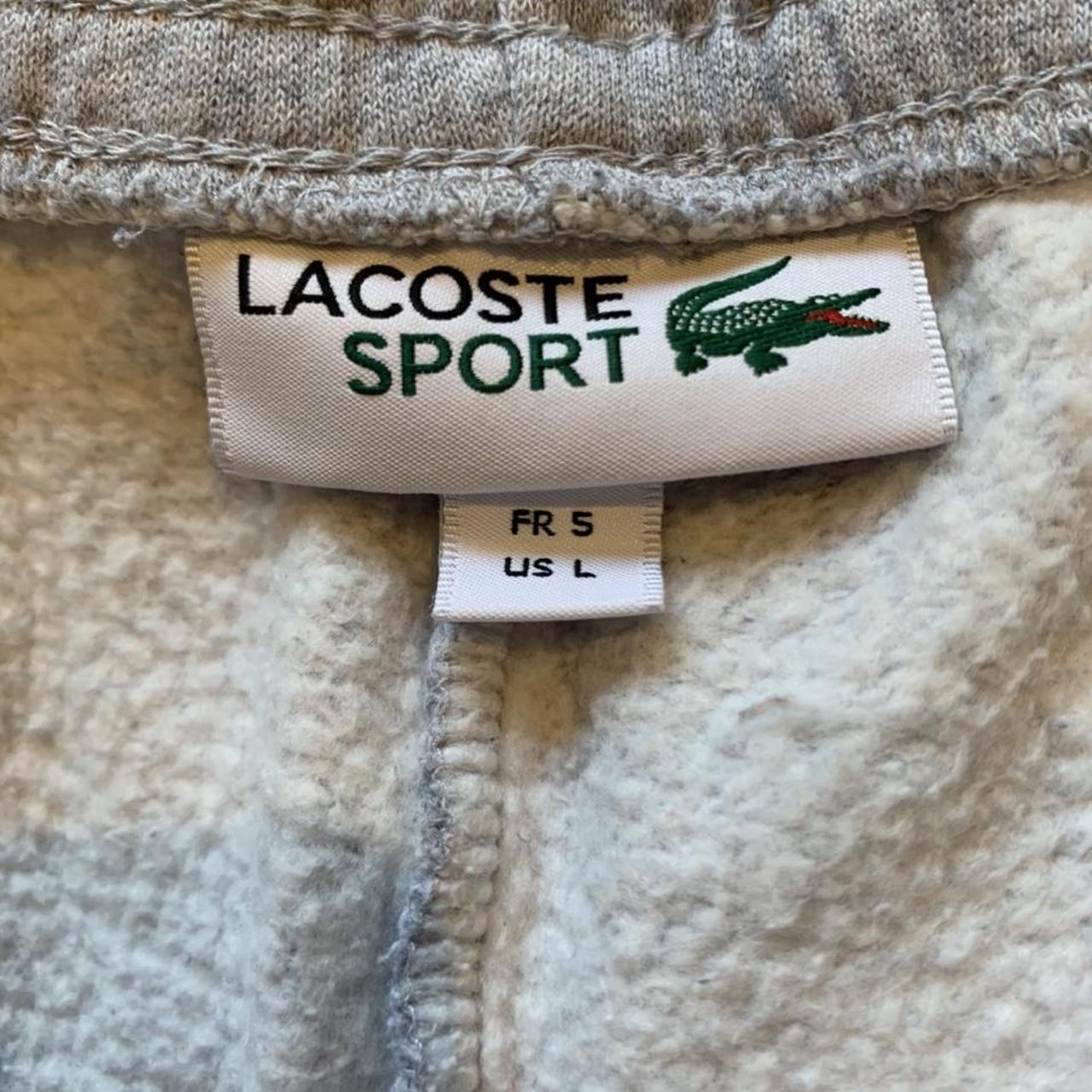 Grey Lacoste tapered tracksuit bottoms... - Depop