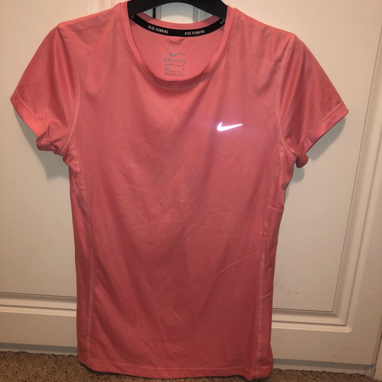 peach color nike shirt