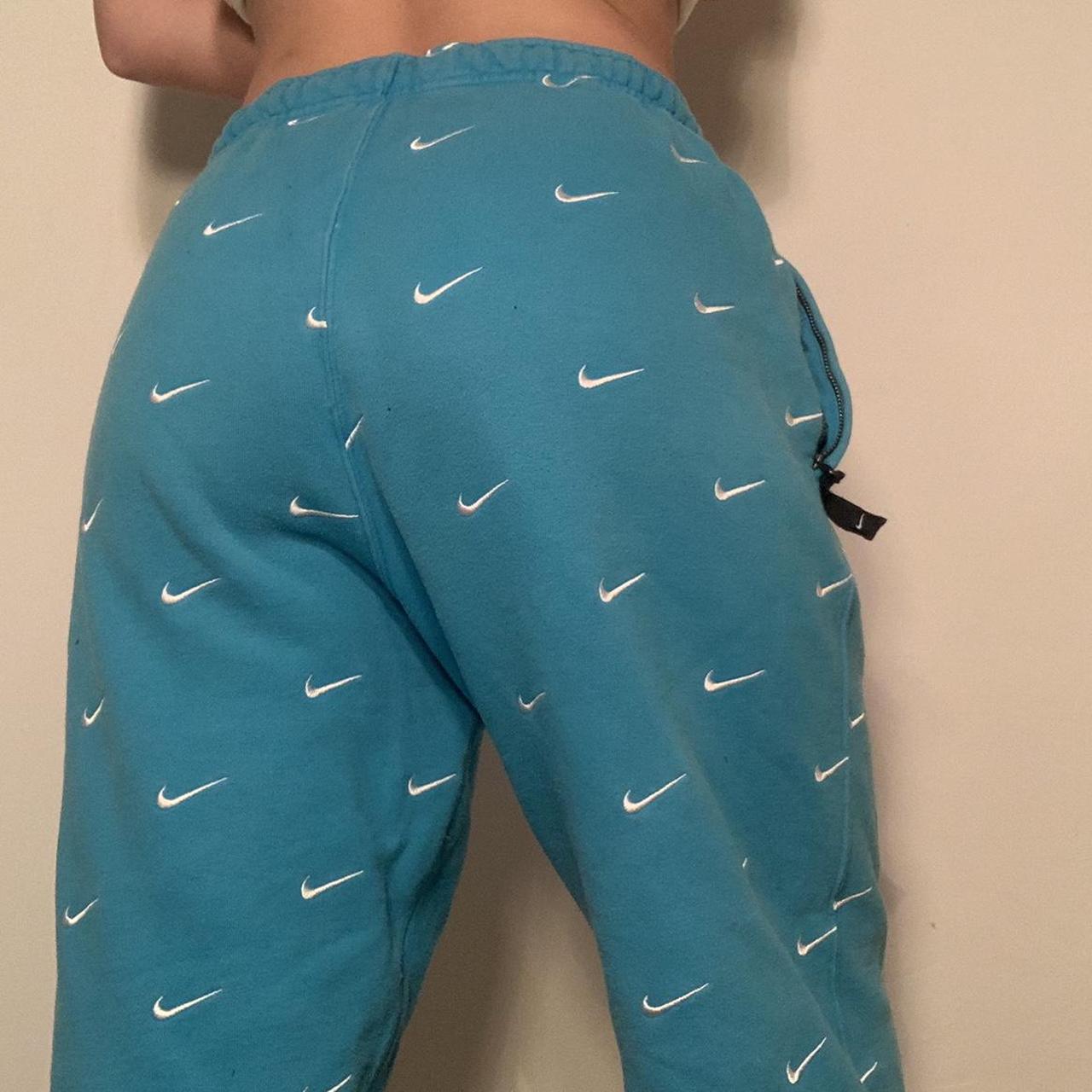 nike all over swoosh logo pants