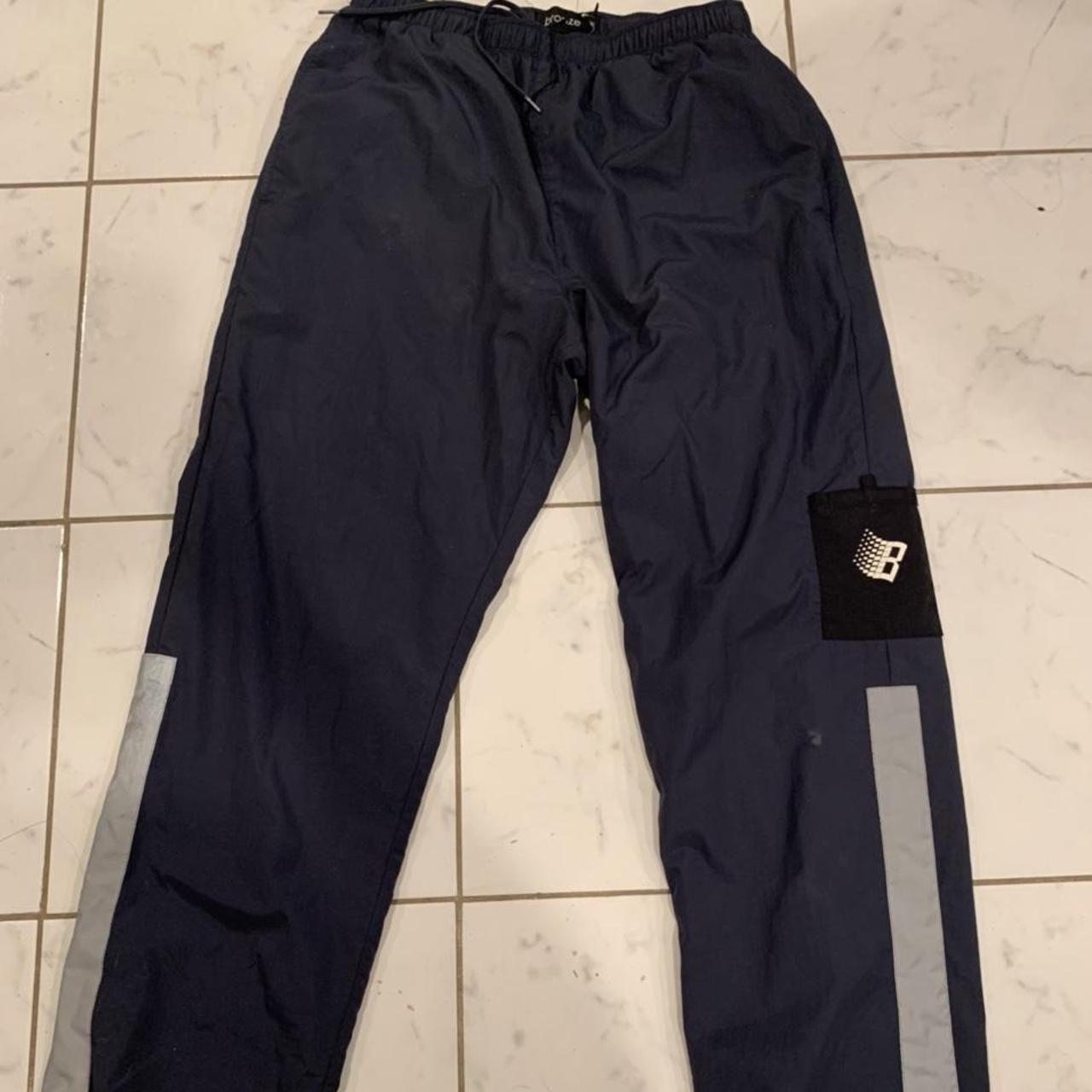 BRONZE 56k TRACK PANTS IN NAVY BLUE , SIZE MEDIUM Can...