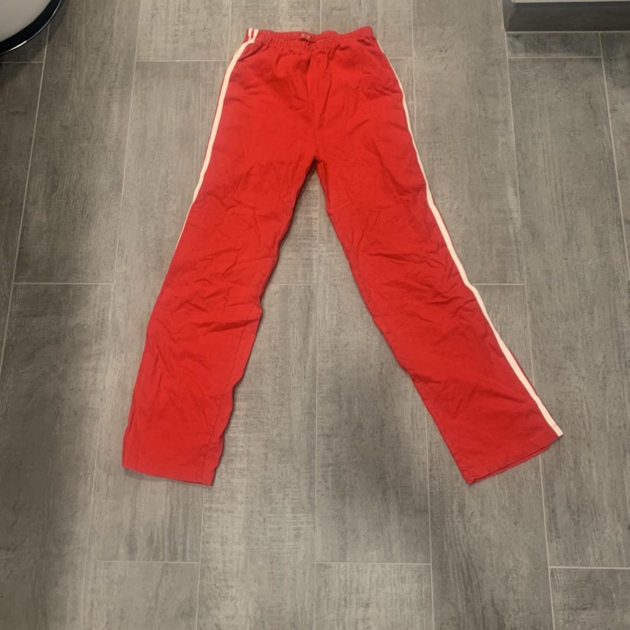 Brandy Melville red track pants made out of a cotton... Depop