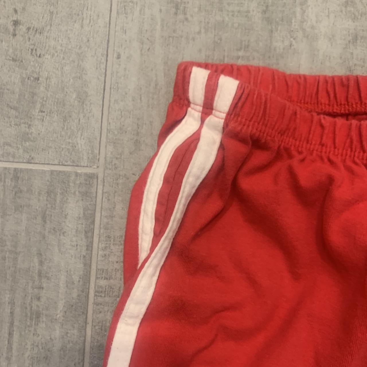 Brandy Melville red track pants made out of a cotton... Depop