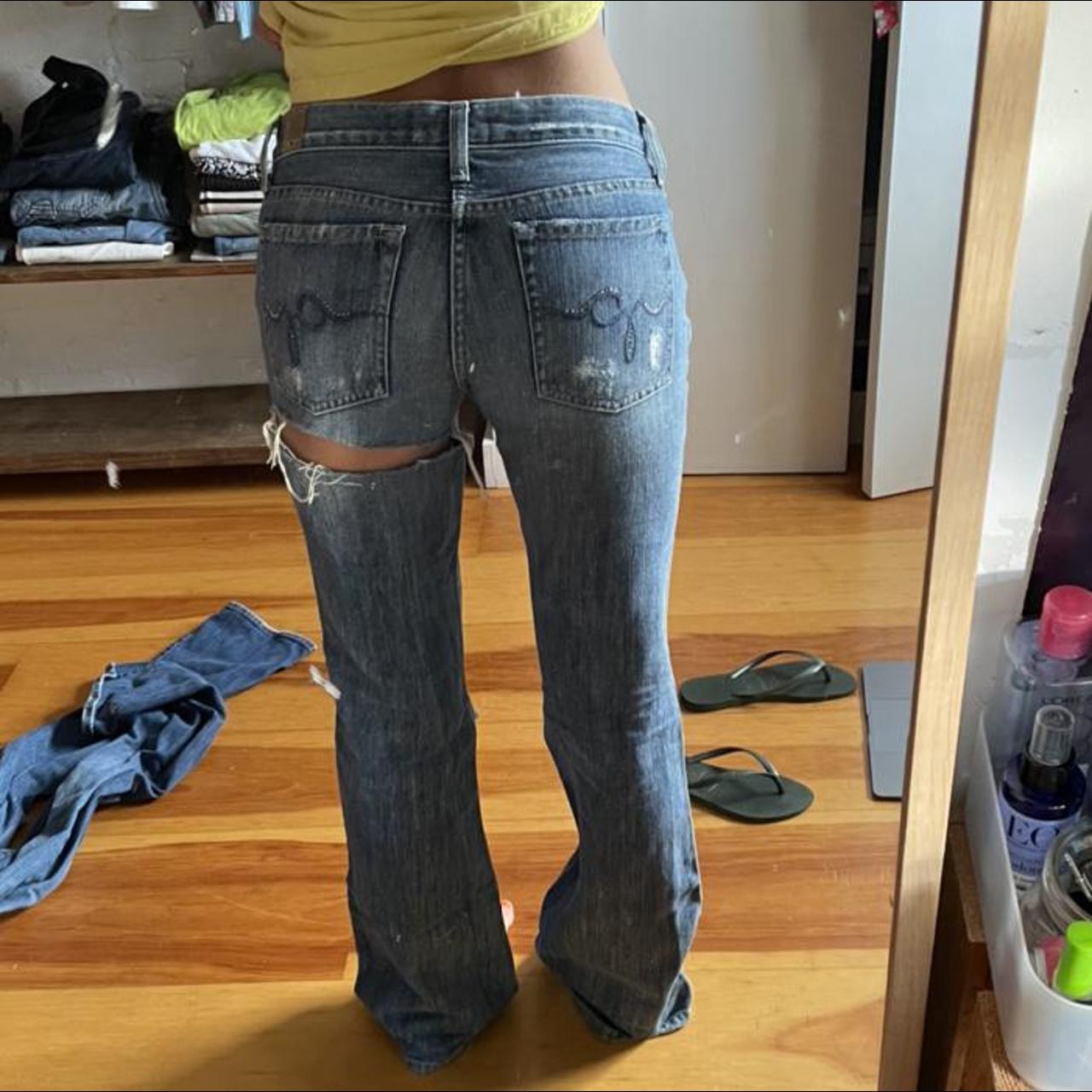 Y2K low waisted flared jeans with rip on knee and... - Depop