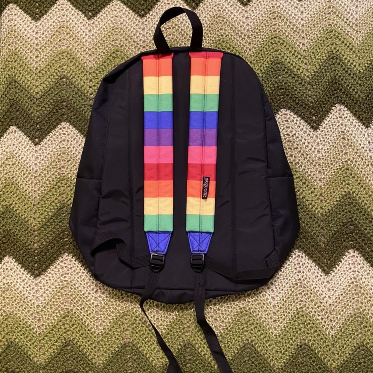 Black Jansport backpack with bright rainbow stripe