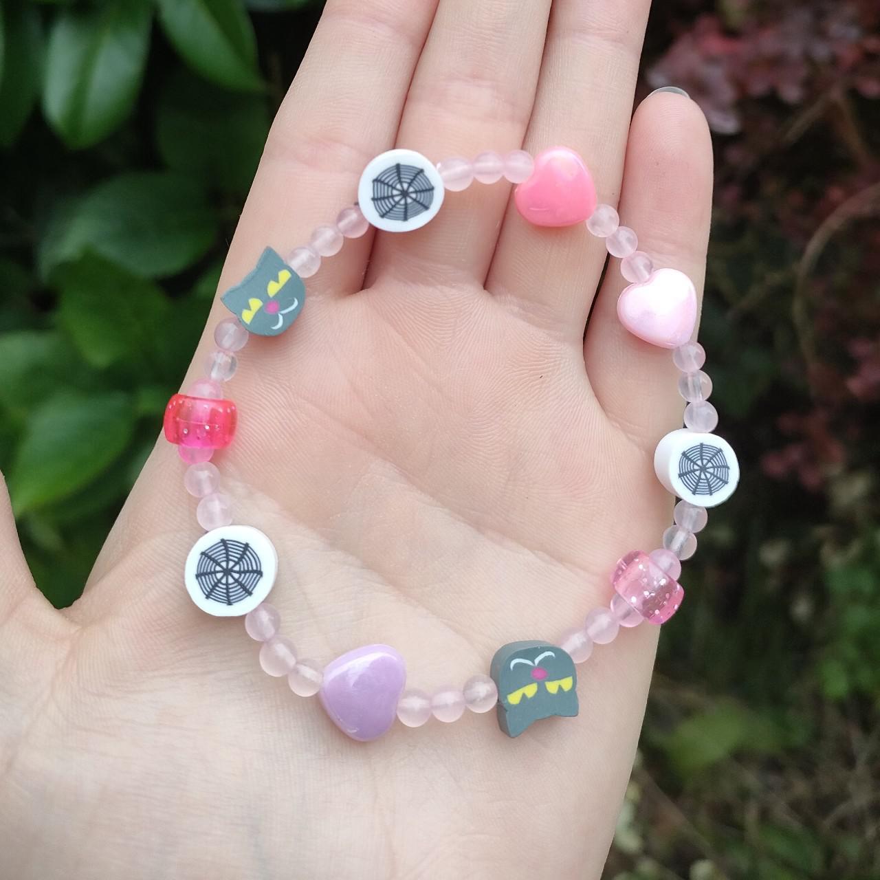 clay beads bracelets. one is purple with a flower - Depop