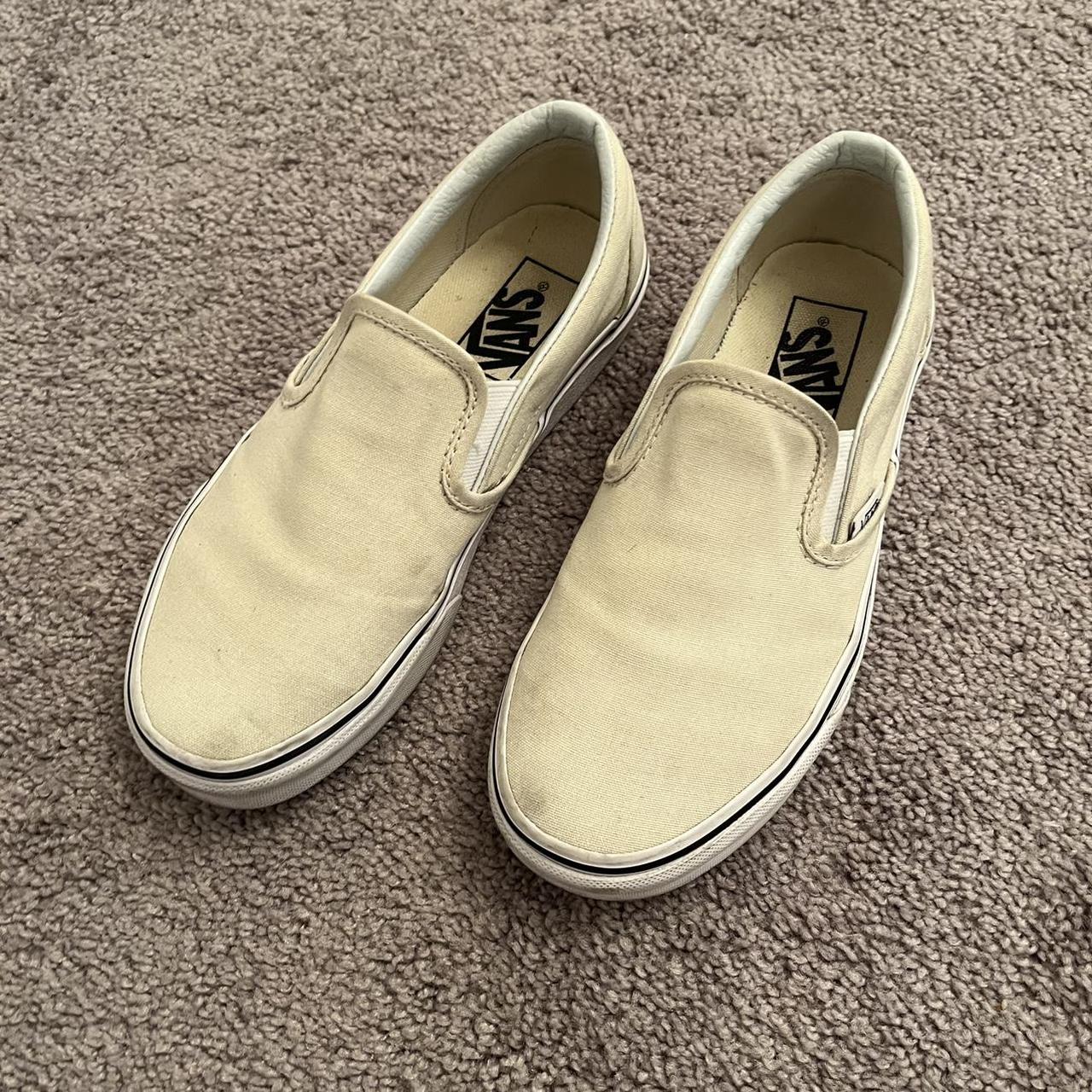 cream colored slip on vans