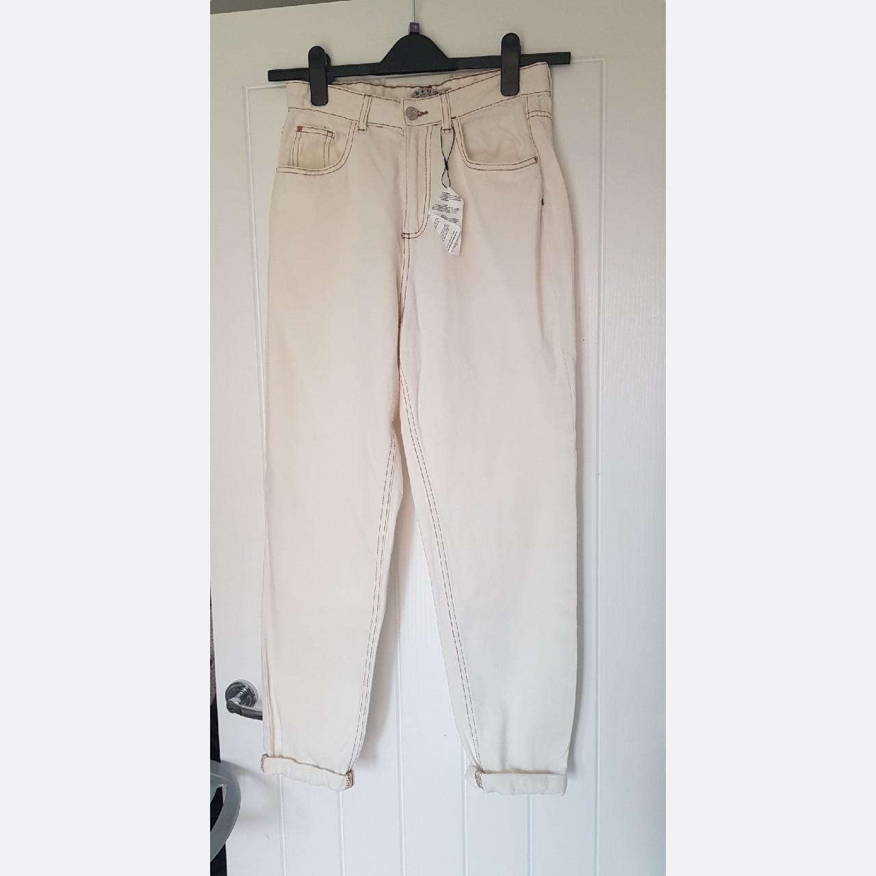 white mom jeans with brown stitching