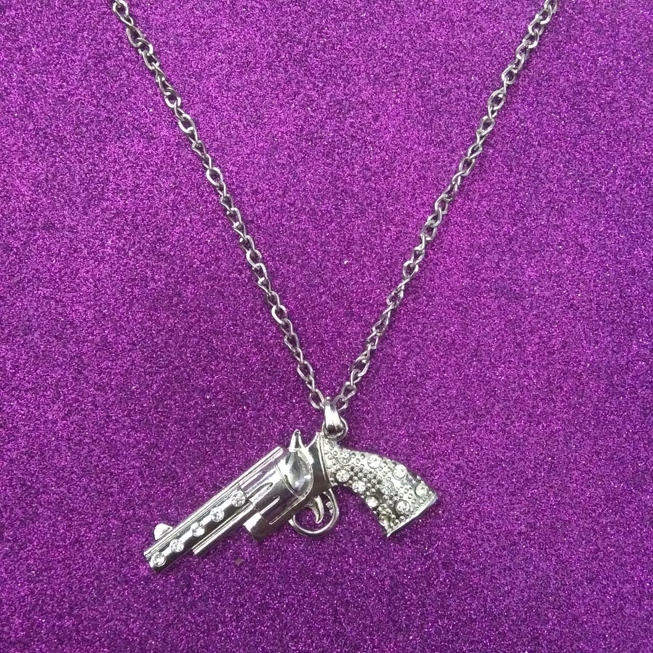 Gun necklace with faux bling accents on the gun.... Depop