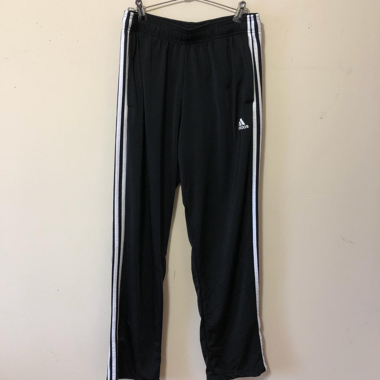 Black Adidas track pants with white stripes. - Depop