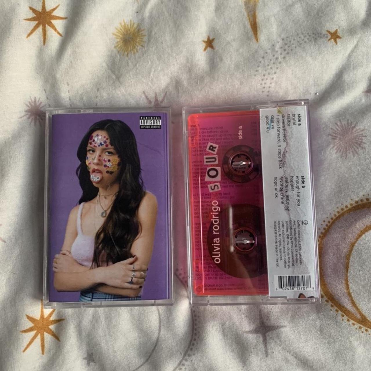 2x Olivia Rodrigo cassettes. One white and one pink,... - Depop