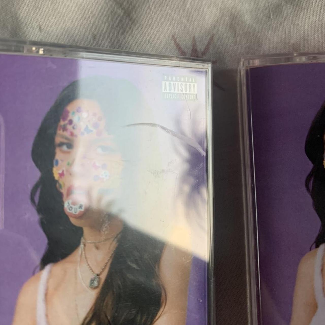 2x Olivia Rodrigo cassettes. One white and one pink,... - Depop