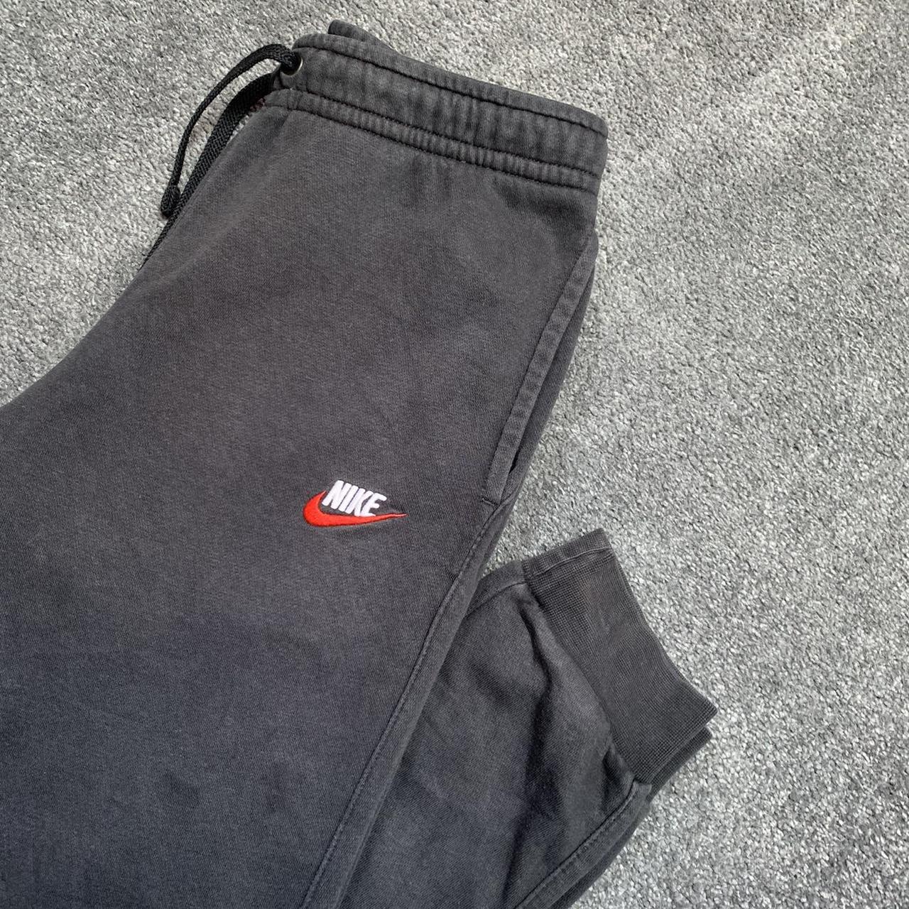 black nike tracksuit bottoms red tick