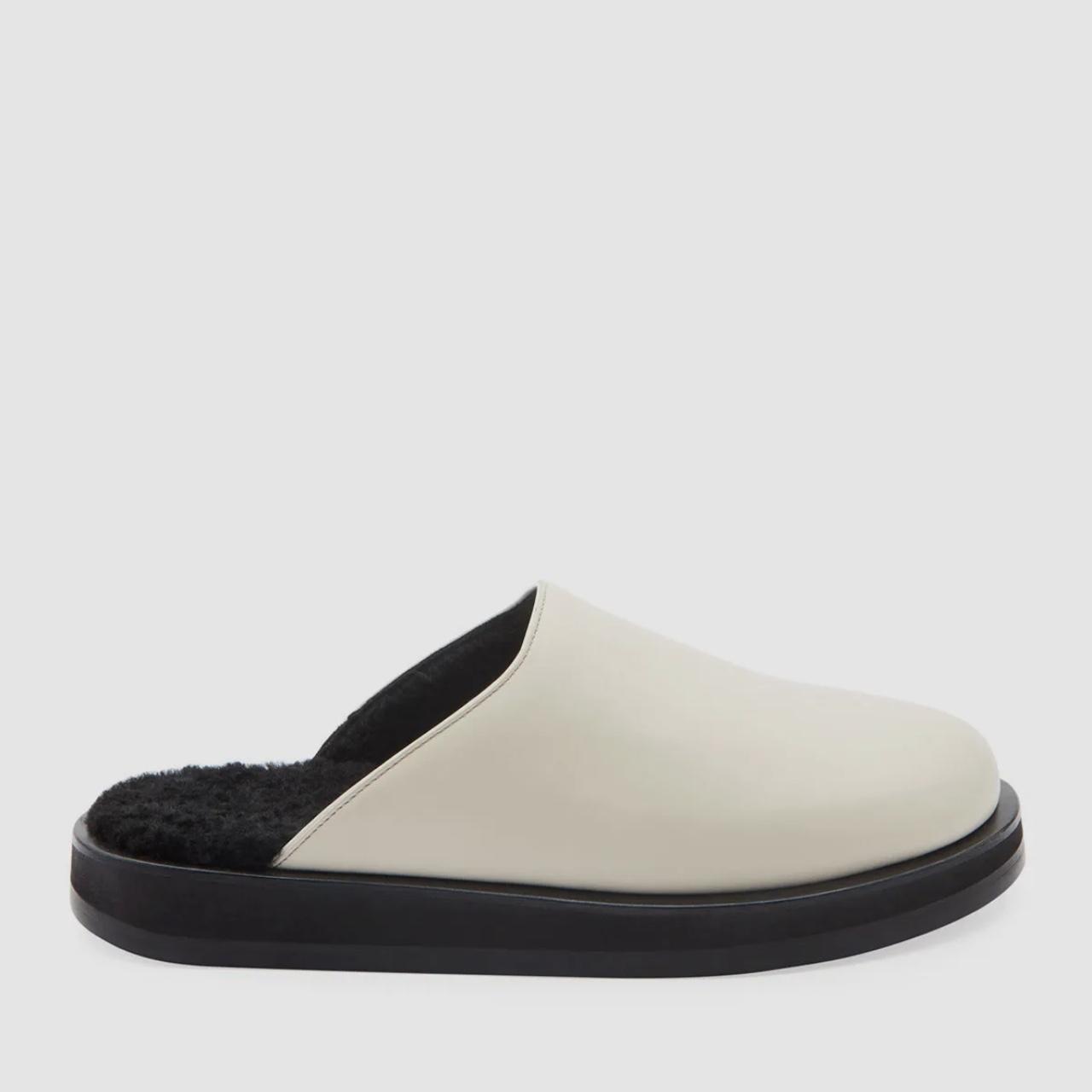 The Row sabot mule in white with black shearling