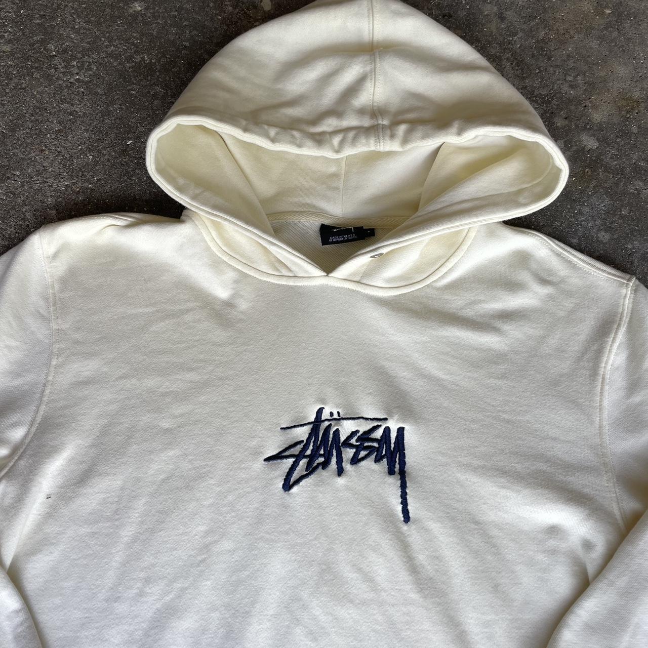 cream stussy center logo hoodie. size large fits... - Depop