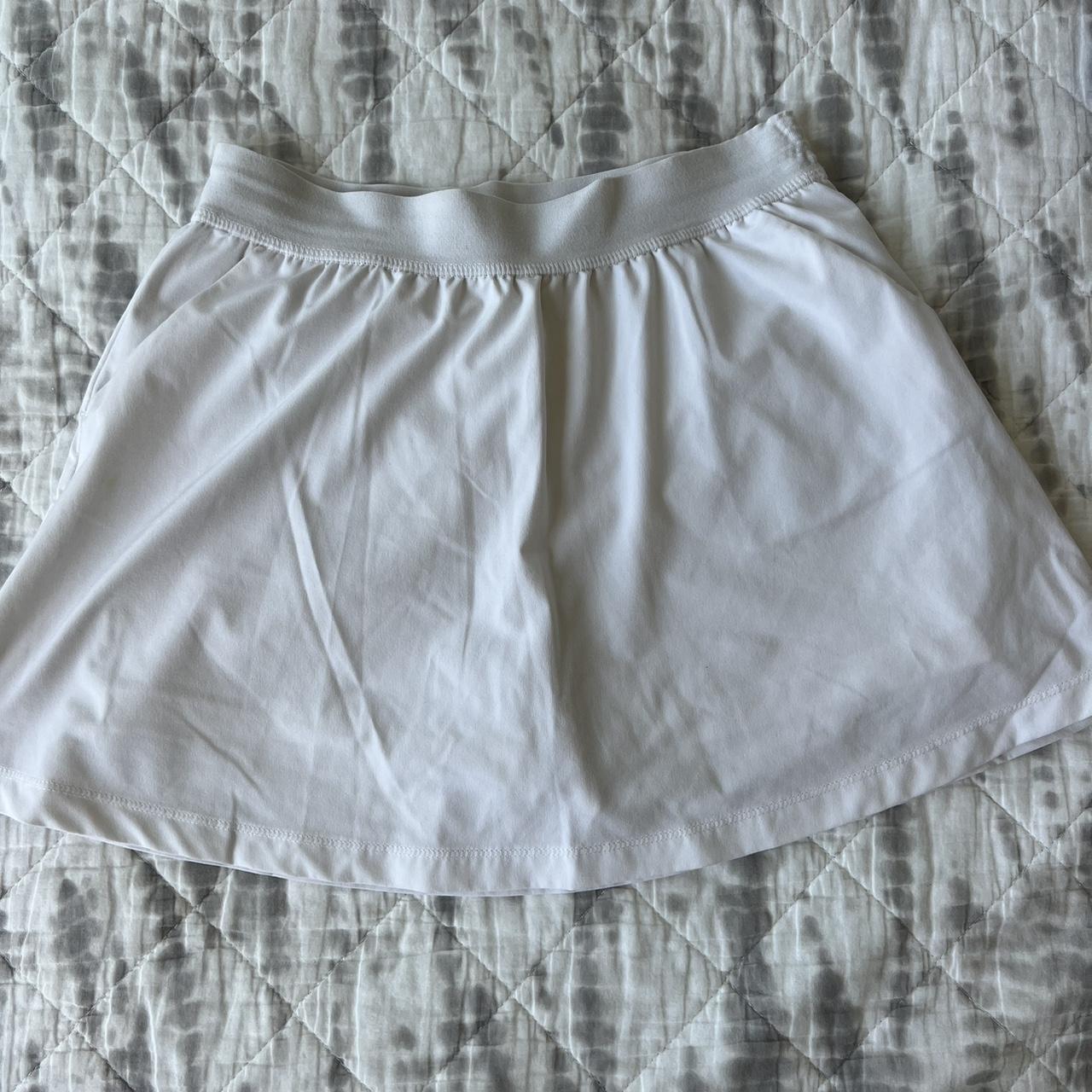 white dsg tennis skirt. thin sporty material with... - Depop