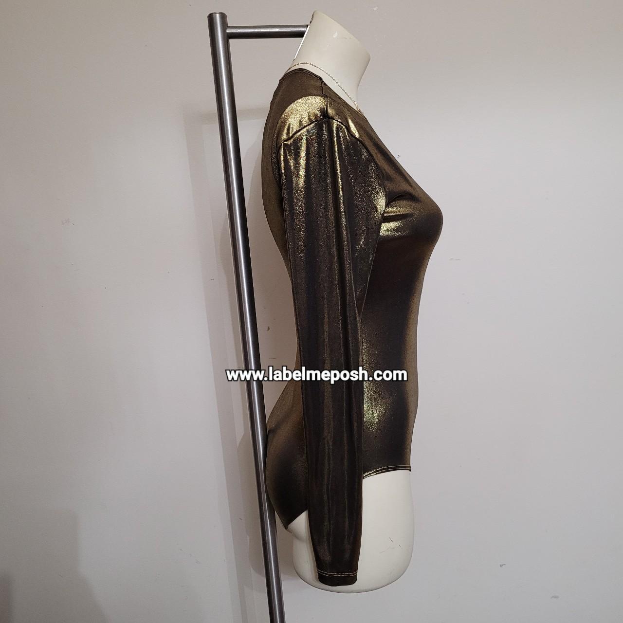 This is metallic bodysuit in the color gold. Very... Depop