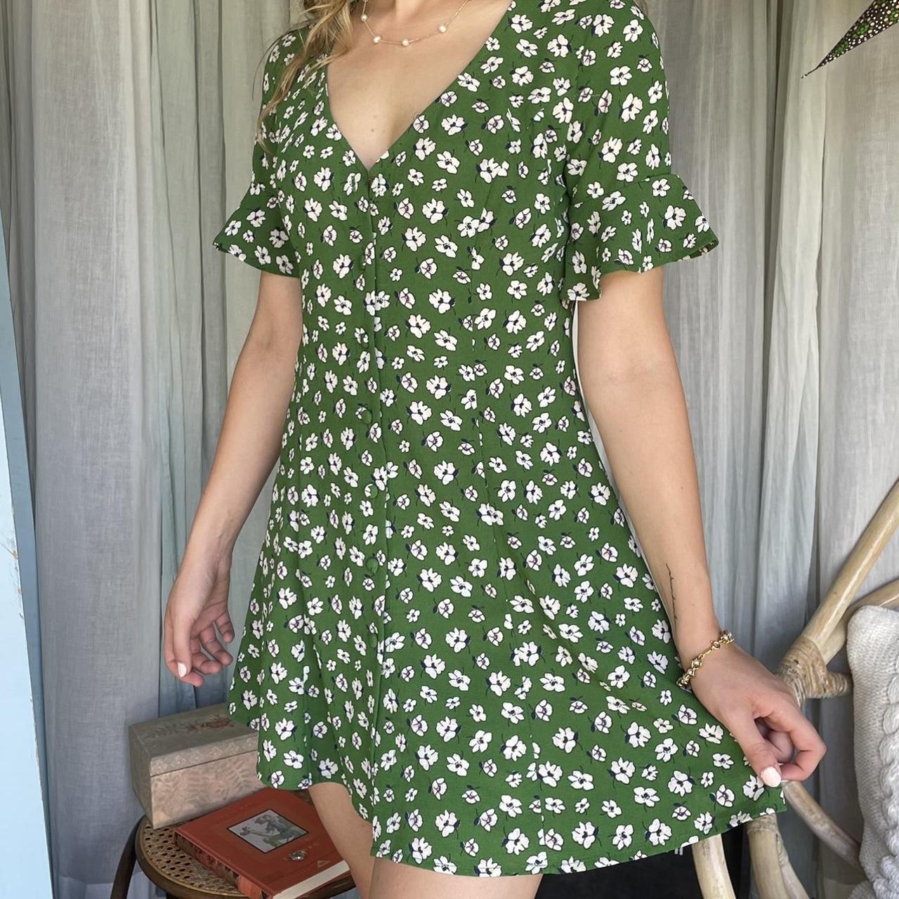 Green dress with white flowers that have shades of