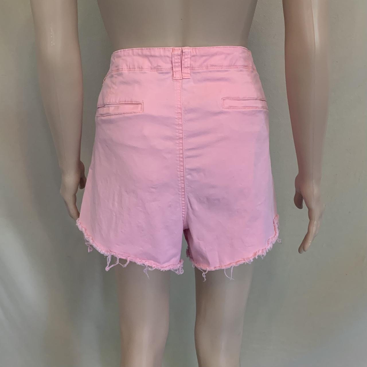 Ripped pink jean shorts brand is Bandolino. Good